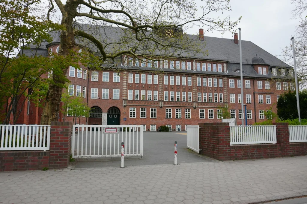 Brick school building behind an open gate