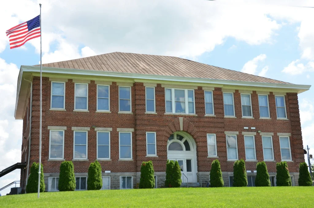Red brick school building with an American flag